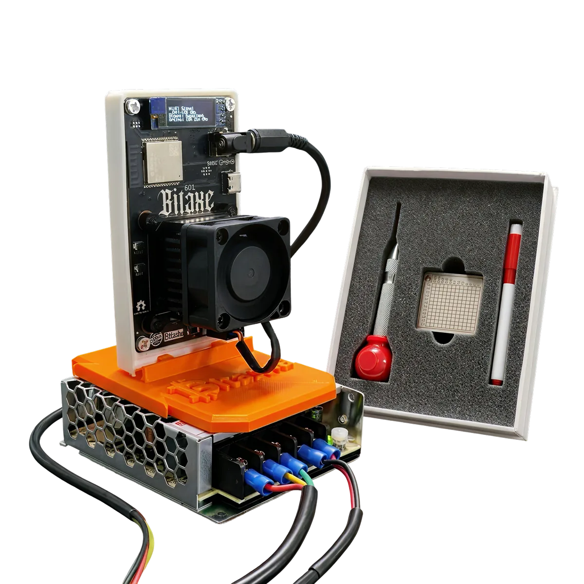 Bitaxe miner on its power supply beside an open Koshh kit