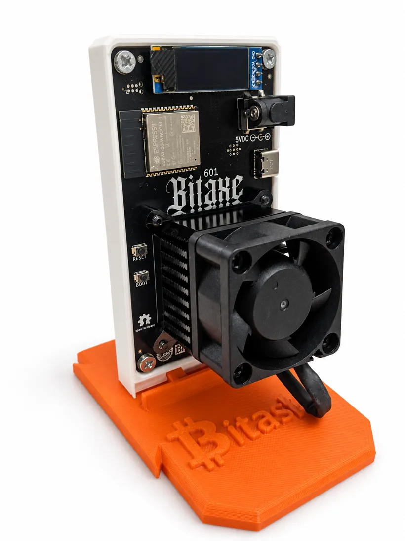 Bitaxe Gamma 601 on its orange Bitasha stand, three-quarter view